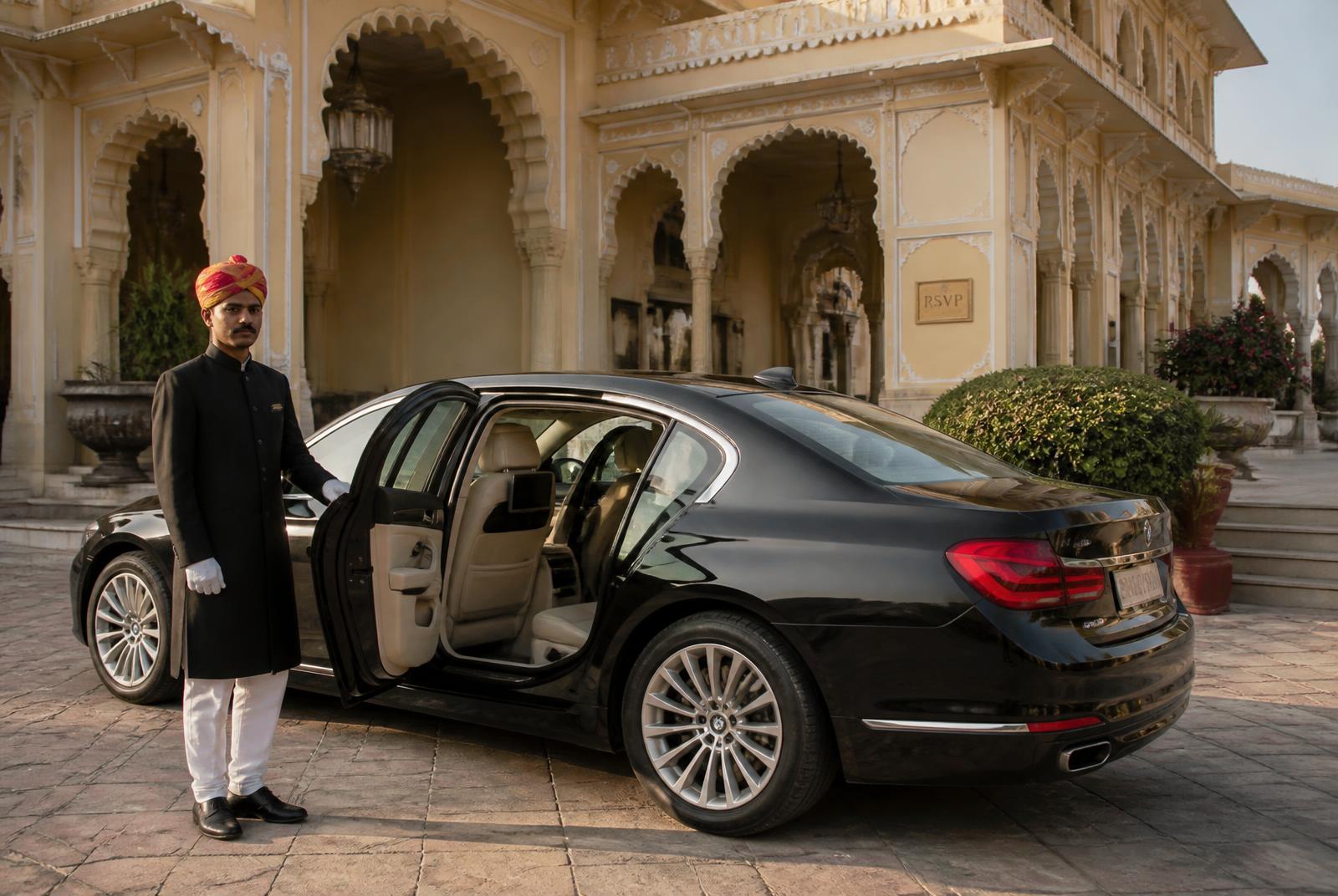 Chauffeur beside a luxury car in Jaipur